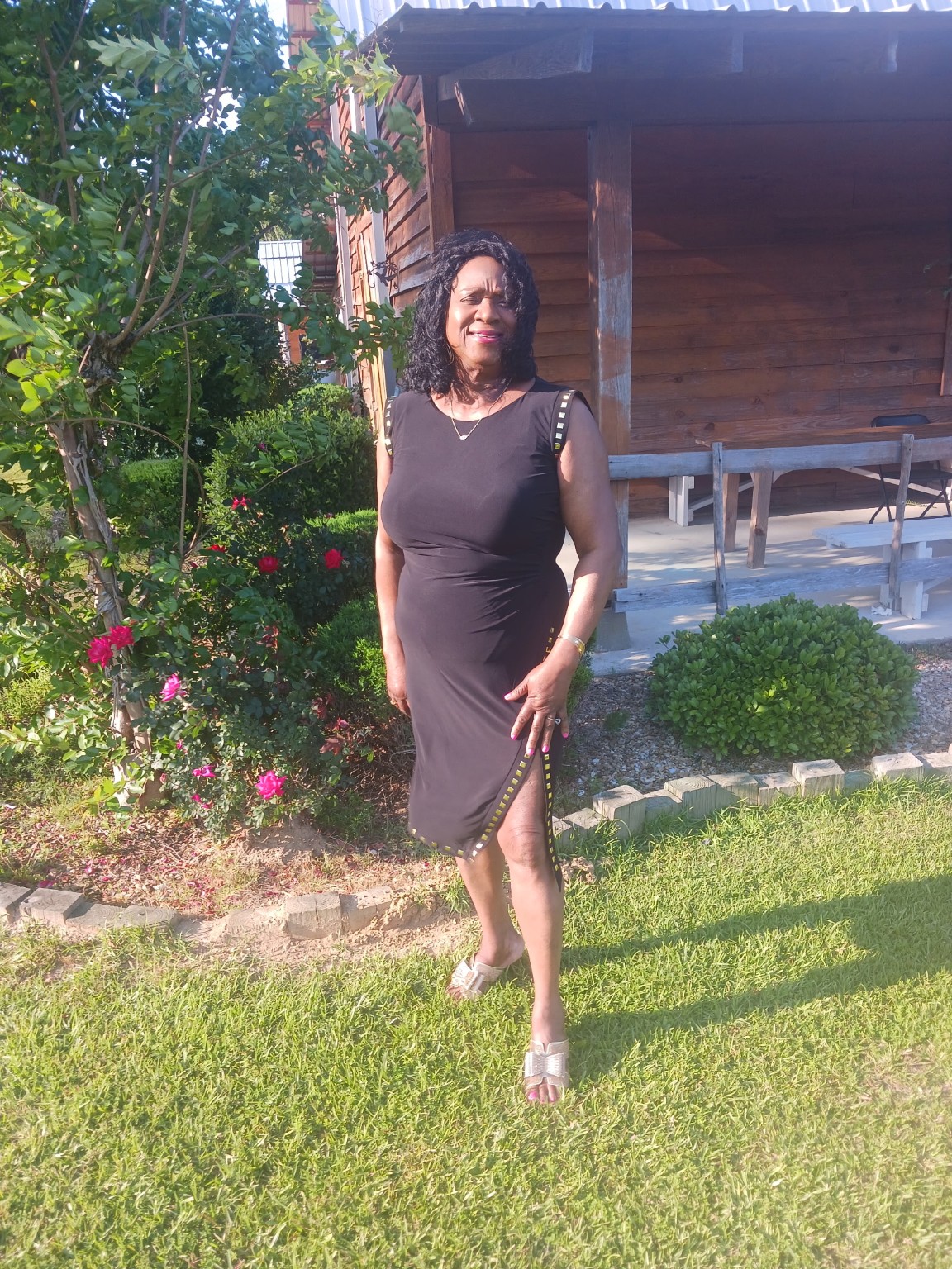Jackie smiling in an elegant black dress